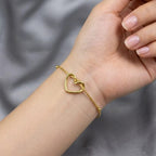 Stainless Steel Heart Bracelet features a delicate golden chain with a minimalist intertwined heart pendant